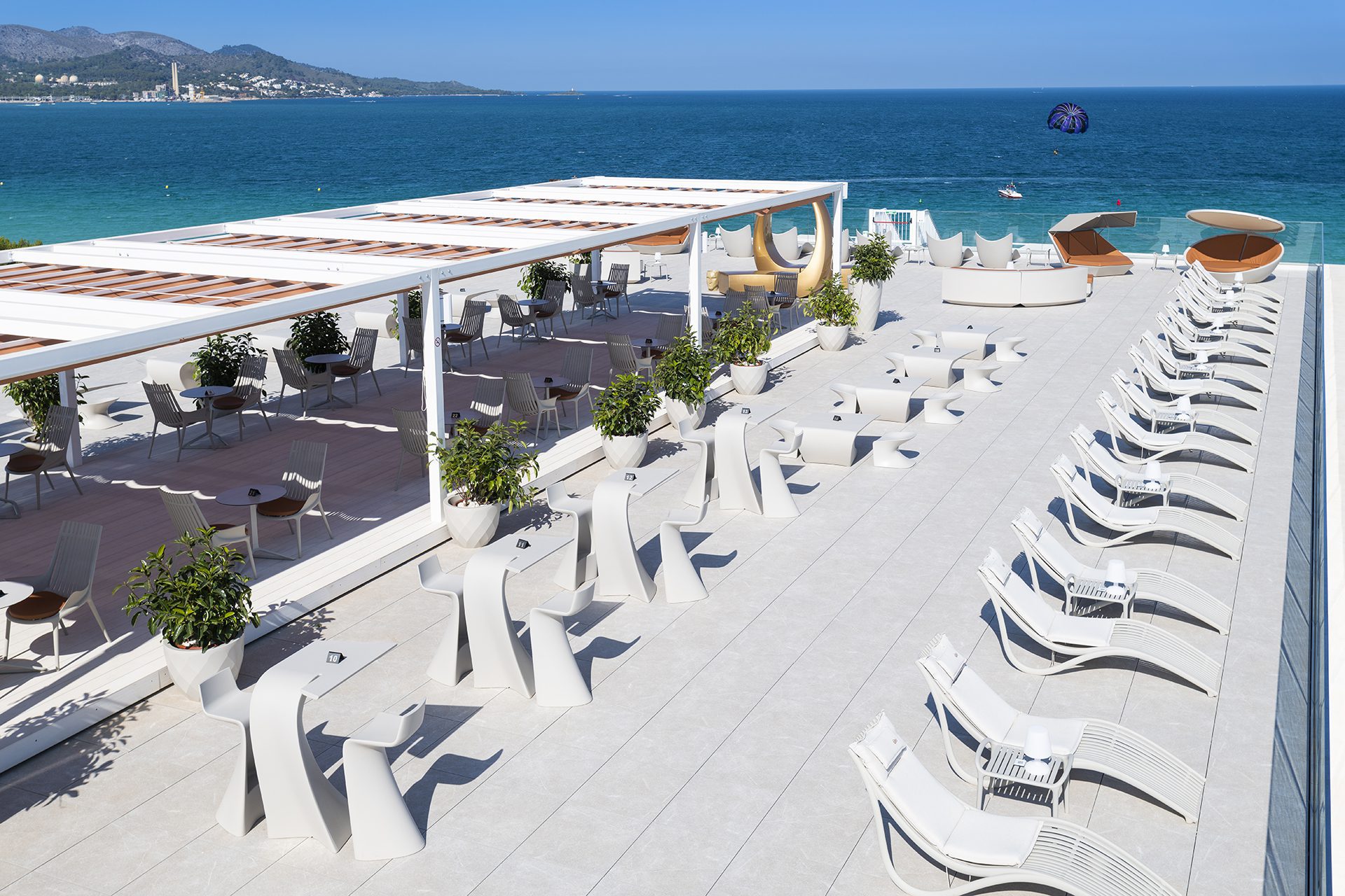 Outdoor contract furniture Ibiza sun loungers, Wing stool and table, and Vases planters, hospitality furniture by Vondom