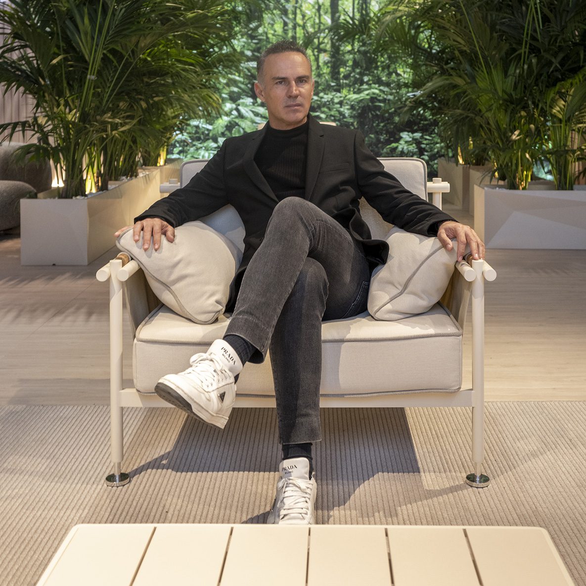 Ramón Esteve sitting in the Hamptons armchair during his visit to Vondom's stand at Salone del Mobile 2023.